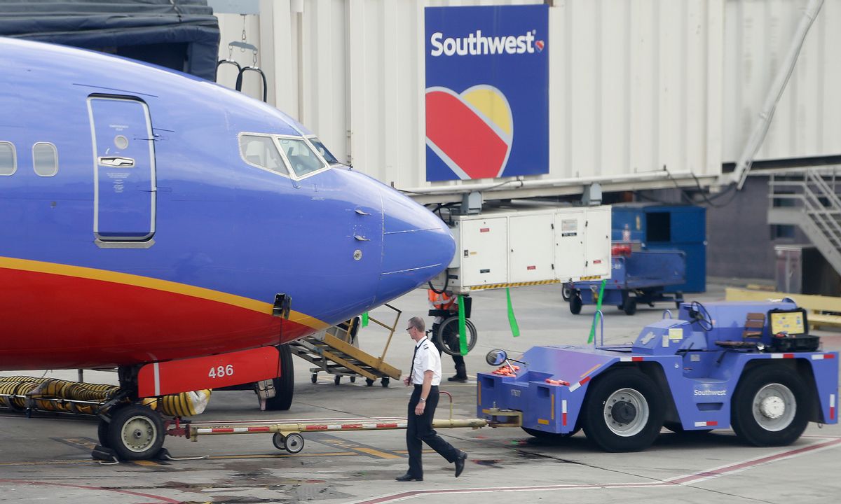 In this Monday, May 9, 2016, photo, a Southwest Airlines pilot performs a preflight check on an aircraft at Hartsfield–Jackson Atlanta International Airport, in Atlanta. Southwest Airlines reports financial results Wednesday, Oct. 26, 2016. (AP Photo/Mike Stewart) (AP)