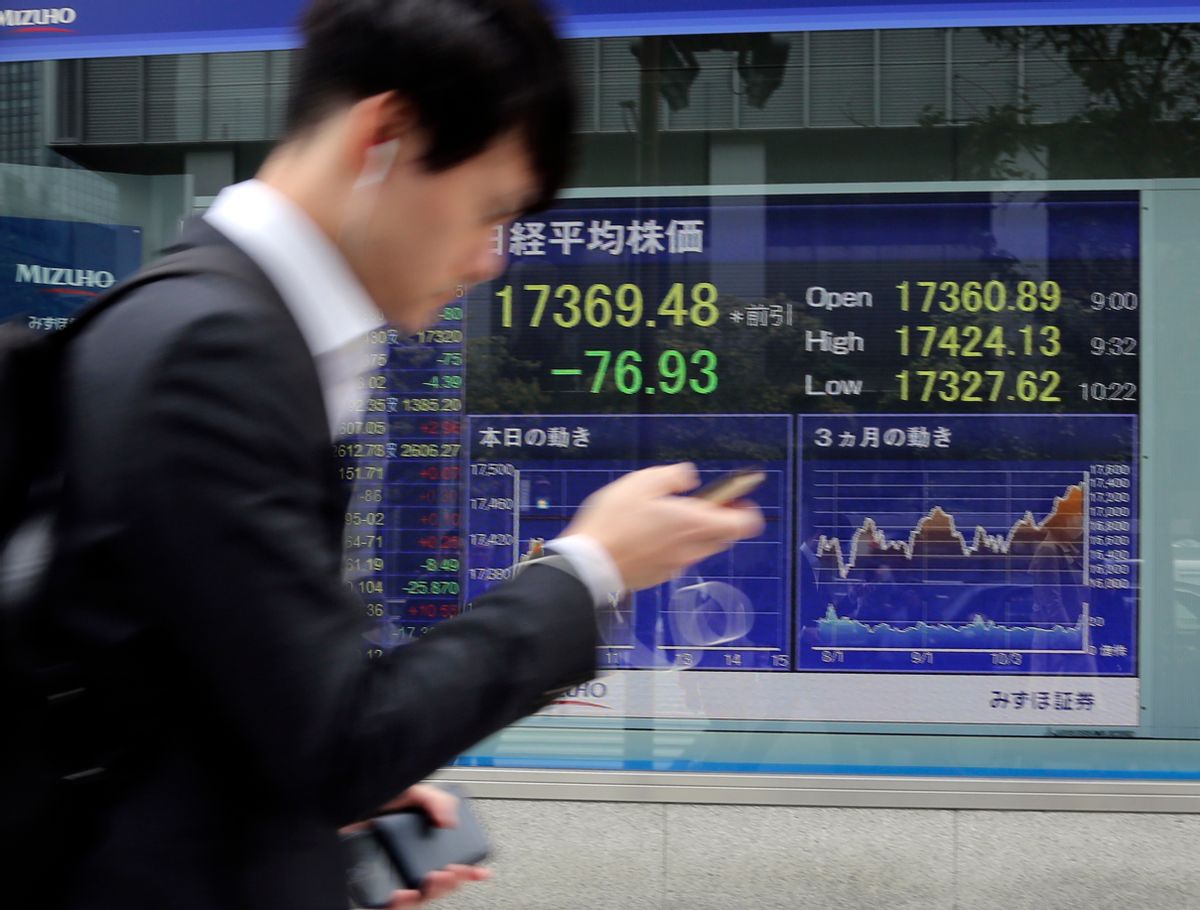 A man walks by an electronic stock board of a securities firm in Tokyo, Monday, Oct. 31, 2016. Asian stocks wobbled Monday as a revived FBI inquiry into U.S. presidential candidate Hillary Clinton's private email server sharpened uncertainty over the election, while investors also awaited key economic data this week. (AP Photo/Koji Sasahara) (AP)