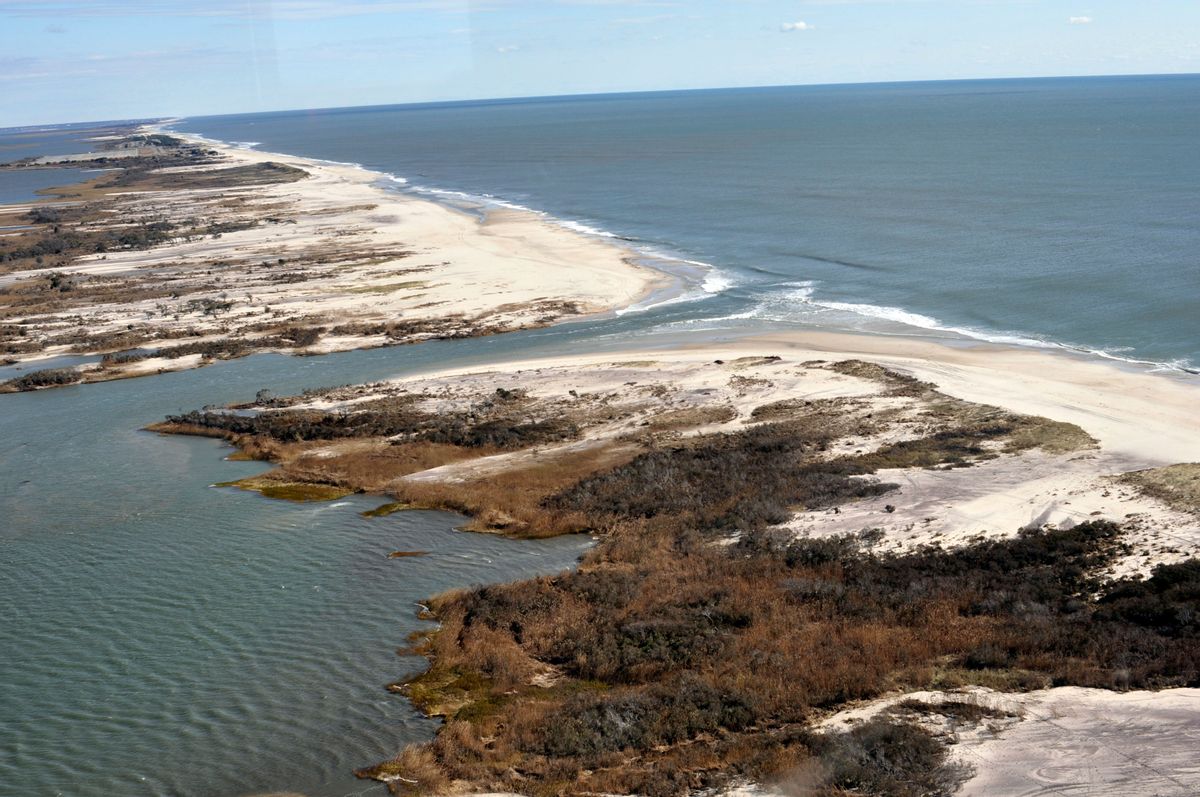 This Nov. 3, 2012 aerial photo provided by the National Park Service, taken off Bellport, N.Y., the week after Superstorm Sandy, shows an opening, center, that was created by the storm in the eastern strip of Fire Island that separates the Atlantic Ocean, upper right, from the Great South Bay.  (USGS Cheryl Hapke/National Park Service via AP) (AP)