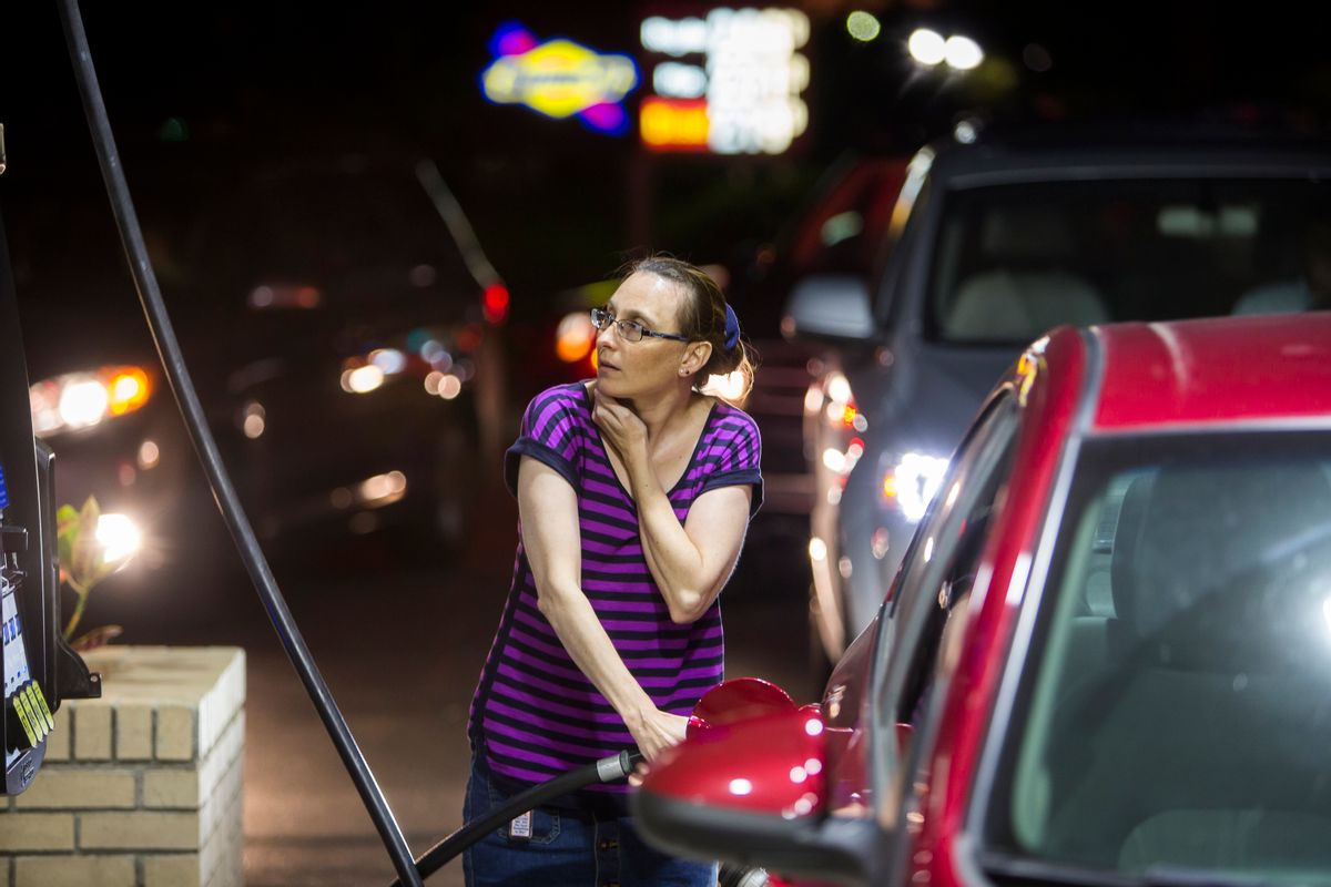 Beth Johnson fills up her car after waiting in line at a Sunoco gas station  in advance of Hurricane Matthew in Mt. Pleasant, S.C., Tuesday, Oct. 4, 2016. Hurricane Matthew is expected to affect the South Carolina coast by the weekend. Gov. Nikki Haley announced Tuesday that, unless the track of the storm changes, the state will issue an evacuation order Wednesday to help get 1 million people inland from the coast.  (AP Photo/Mic Smith) (AP)