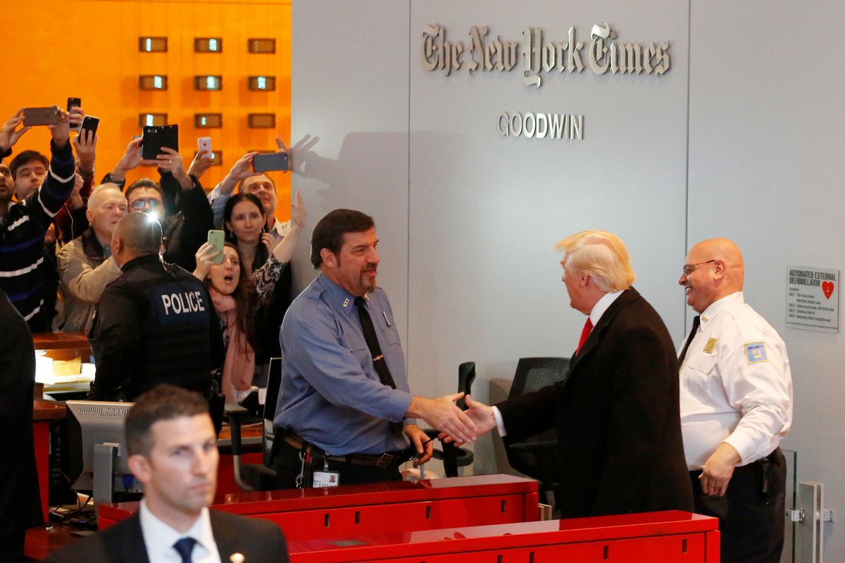 Onlookers watch as President-elect Donald Trump shakes hands with a security guard as he leaves the New York Times building following a meeting, Tuesday, Nov. 22, 2016, in New York.  (AP Photo/Mark Lennihan) (AP)
