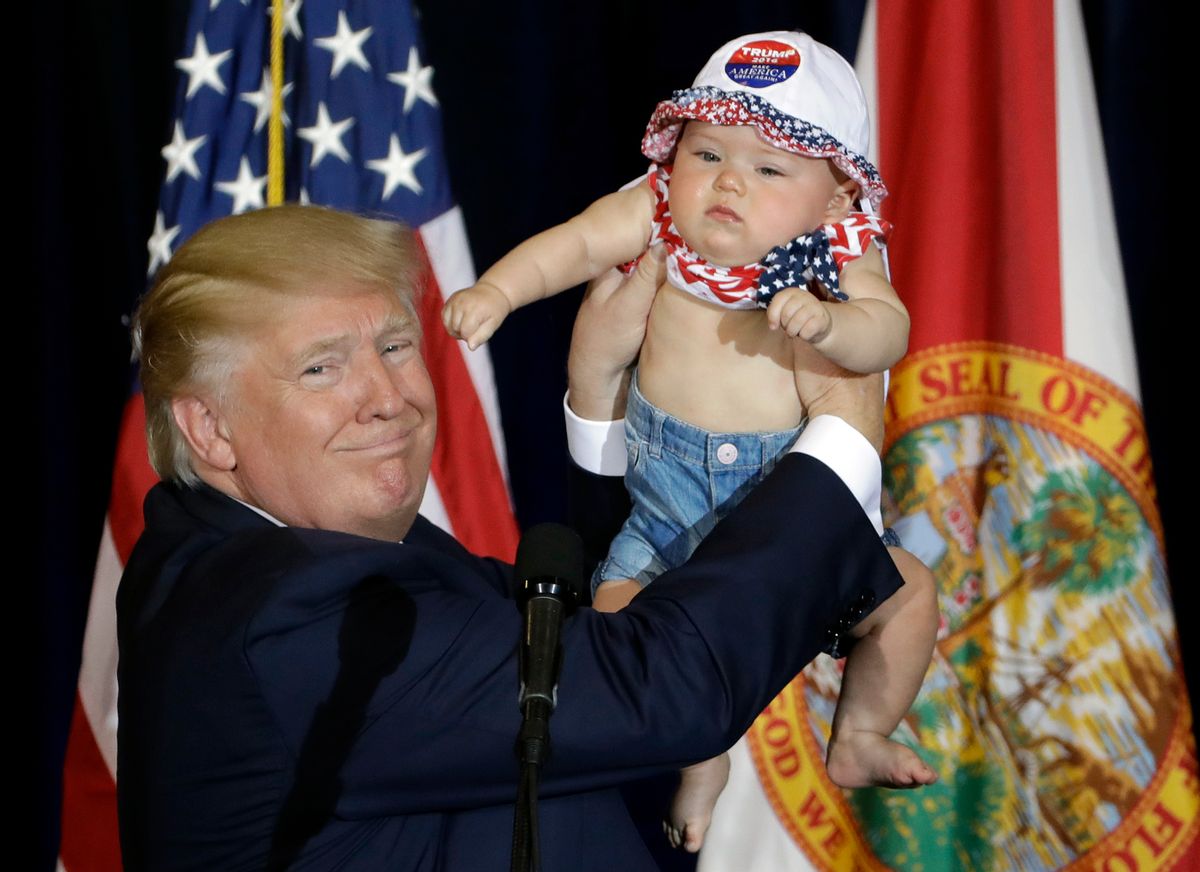 Republican presidential candidate Donald Trump holds up 6-month-old Catalina Larkin, of Largo, Fla., during a campaign rally Saturday, Nov. 5, 2016, in Tampa, Fla. (AP Photo/Chris O'Meara) (AP)