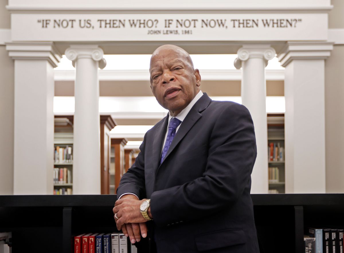 Rep. John Lewis, D-Ga., poses for a photograph under a quote of his that is displayed in the Civil Rights Room in the Nashville Public Library Friday, Nov. 18, 2016, in Nashville, Tenn.  (AP)