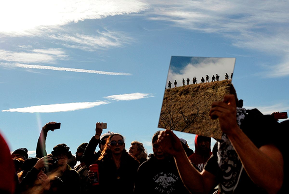 A protester holds up a mirror during a protest of the Dakota Access pipeline on the Standing Rock Indian Reservation near Cannon Ball, North Dakota (Reuters)