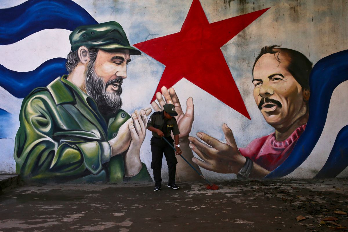 A woman sweeps the Cuba Plaza backdropped by a mural depicting Cuba's former President Fidel Castro and Nicaragua's President Daniel Ortega, in Managua, Nicaragua, Friday, Nov. 4, 2016. An estimated 3 million Nicaraguans will go to the polls on Sunday to vote in their country's general election. Ortega and his running mate, wife Rosario Murillo, are considered shoo-ins for the country's top leadership positions. (AP Photo/Esteban Felix) (AP)