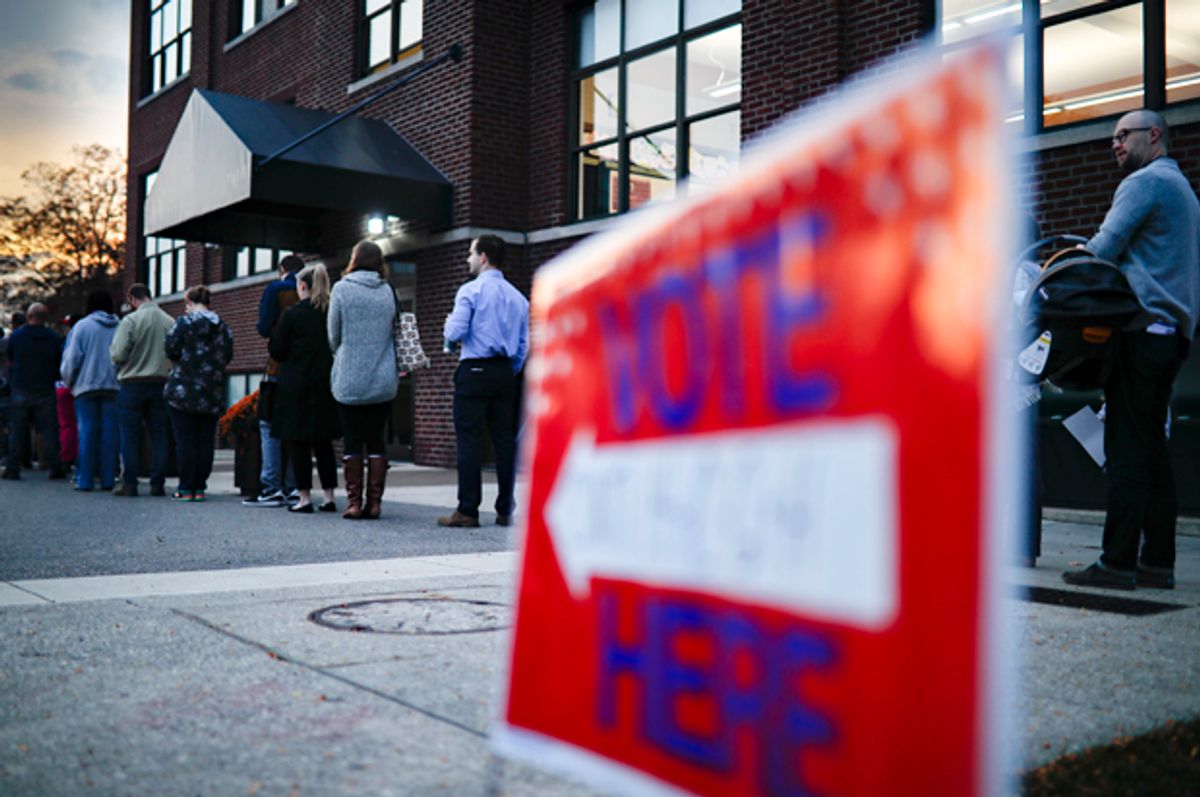 Voters wait in line outside a polling place in Cincinnati   (AP/John Minchillo)