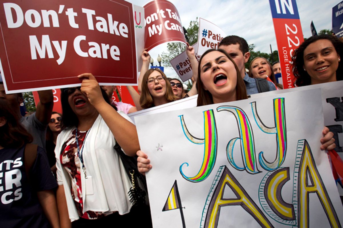 Supporters of the Affordable Care Act react with cheers as the opinion for health care is reported outside of the Supreme Court in Washington   (AP/Jacquelyn Martin)