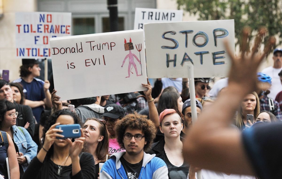 Protesters at an anti-Donald Trump rally listen to one of the speakers in Hemming Park, Saturday, Nov. 12, 2016, in downtown Jacksonville, Fla. Over a hundred protesters gathered for a rally against President-elect, Donald Trump, winning the presidential election. Tens of thousands of people marched in streets across the United States on Saturday, staging the fourth day of protests of Donald Trump's surprise victory as president.  (Bob Self/The Florida Times-Union via AP) (AP)