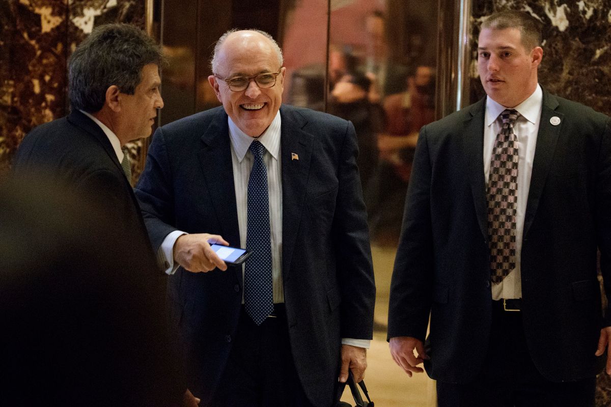 Former New York Mayor Rudy Giuliani, center, smiles as he leaves Trump Tower, Friday, Nov. 11, 2016, in New York. (AP Photo/Evan Vucci) (AP)