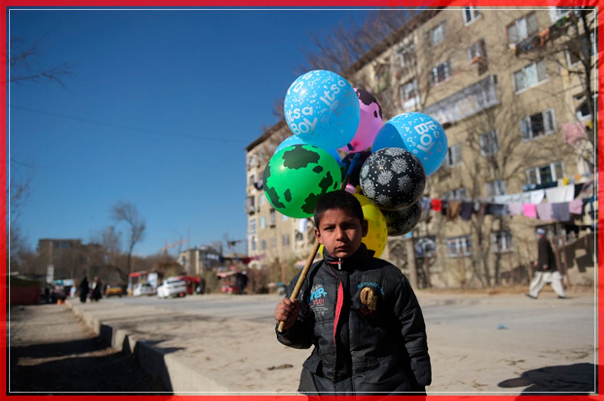 TOPSHOT - An Afghan child who works as a balloon vendor waits for customers in Kabul on December 6, 2016. / AFP / SHAH MARAI        (Photo credit should read SHAH MARAI/AFP/Getty Images) (Afp/getty Images)