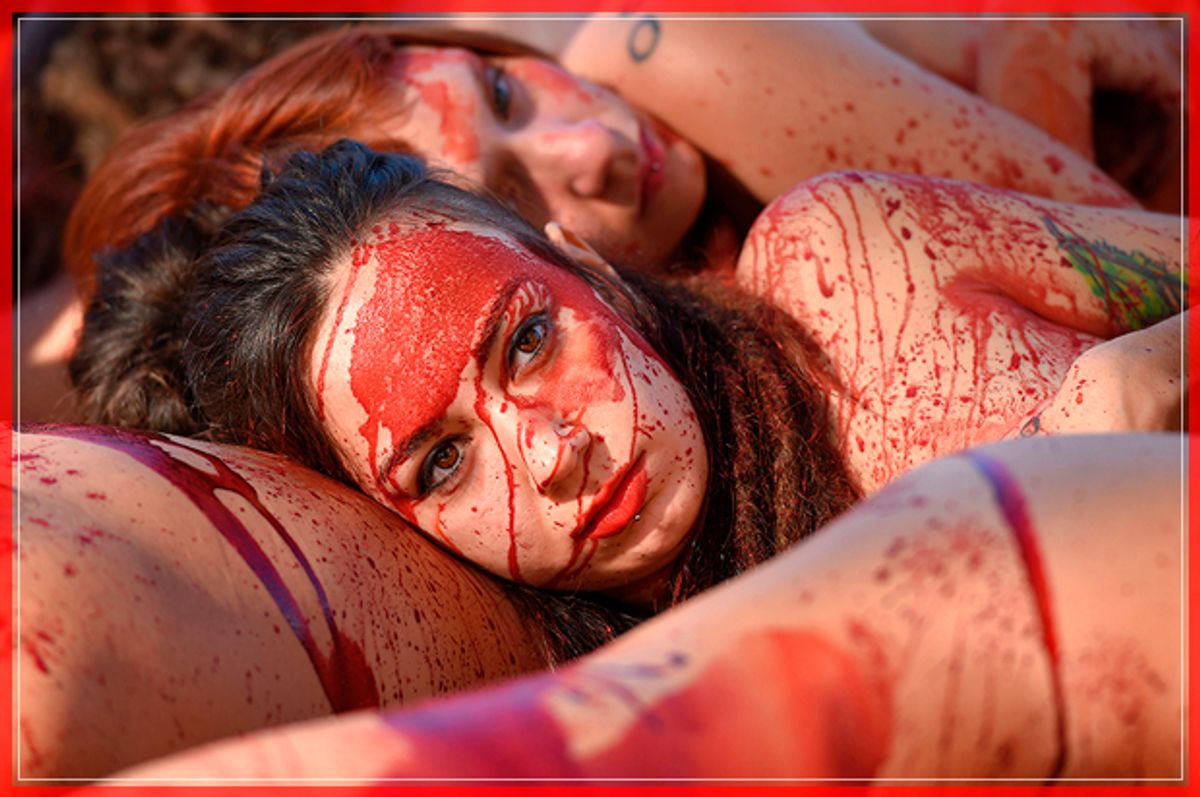 Naked activists of the animal-rights group "AnimaNaturalis" covered with fake blood stage a protest to denounce the use of animal skins, in Barcelona on December 11, 2016. / AFP / LLUIS GENE        (Photo credit should read LLUIS GENE/AFP/Getty Images) (Afp/getty Images)