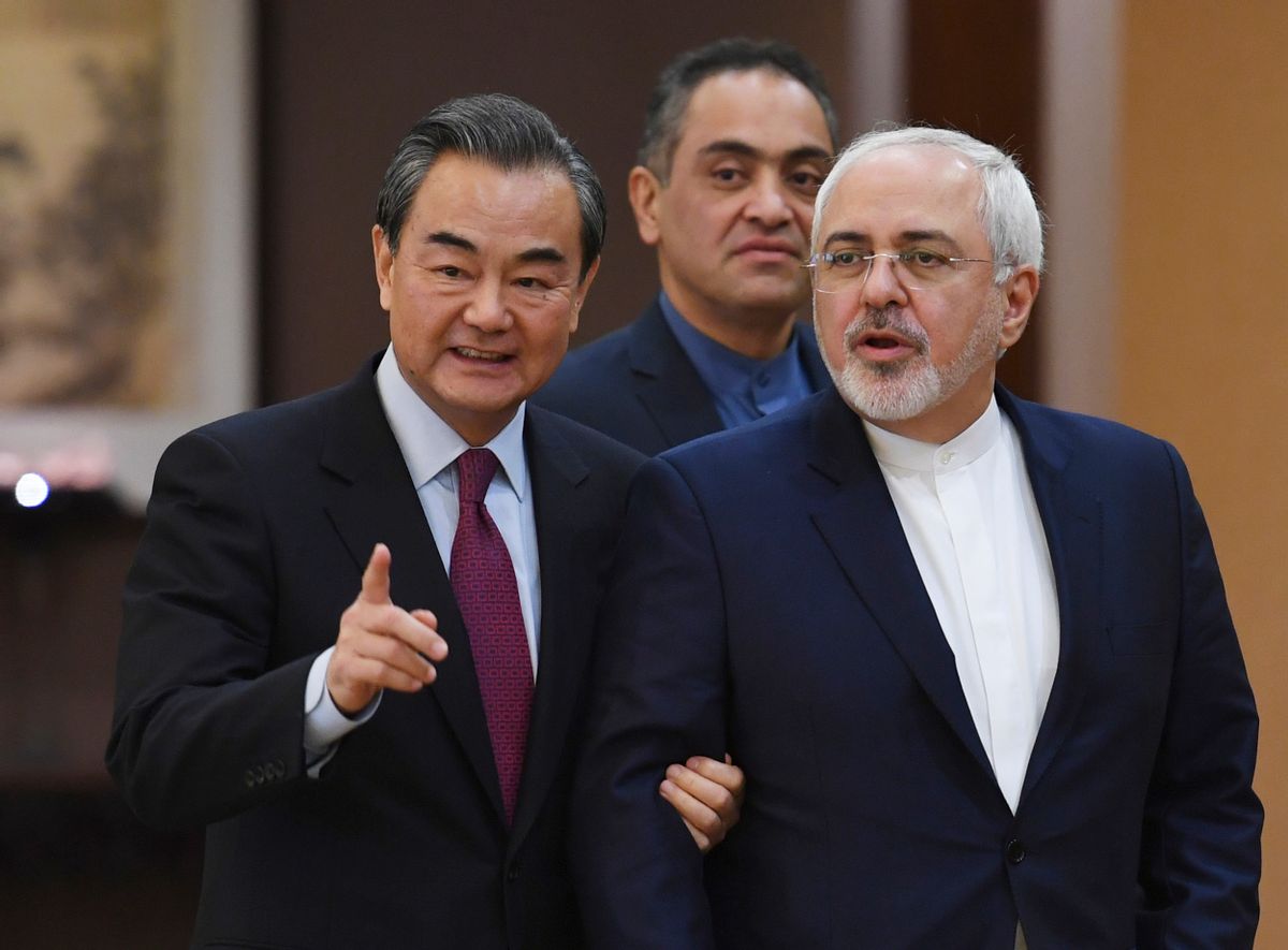Iranian Foreign Minister Mohammad Javad Zarif, right, arrives with Chinese Foreign Minister Wang Yi for a joint press conference in Beijing Monday, Dec. 5, 2016. (Greg Baker/Pool Photo via AP) (AP)