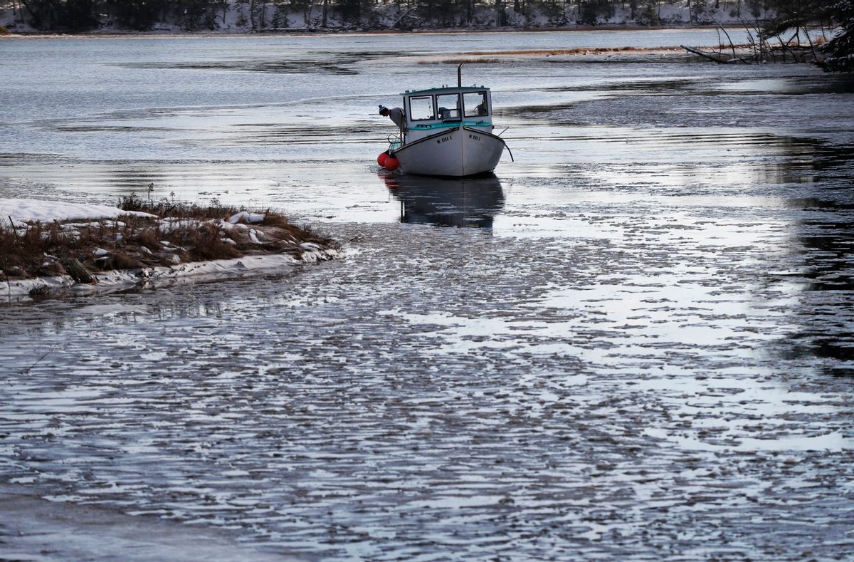 Lobsterman Jack O'Donoghue checks the icy waters of the Harraseeket River as he prepares to have his 30-foot fishing boat, the Mary Elizabeth, hauled out of the water for winter, Thursday, Dec. 15, 2016, in Freeport, Maine. (AP Photo/Robert F. Bukaty) (AP)