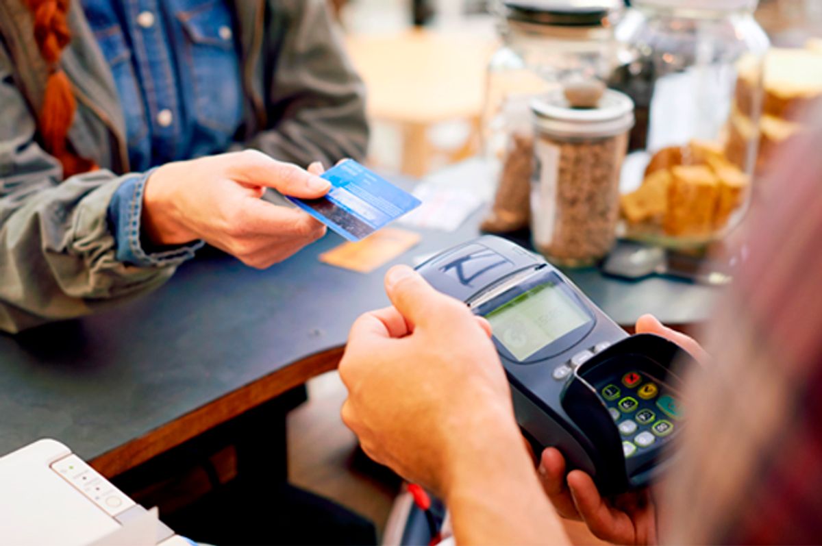 Shot of a customer paying for their order with a credit card machine in a cafe (Getty/PeopleImages)