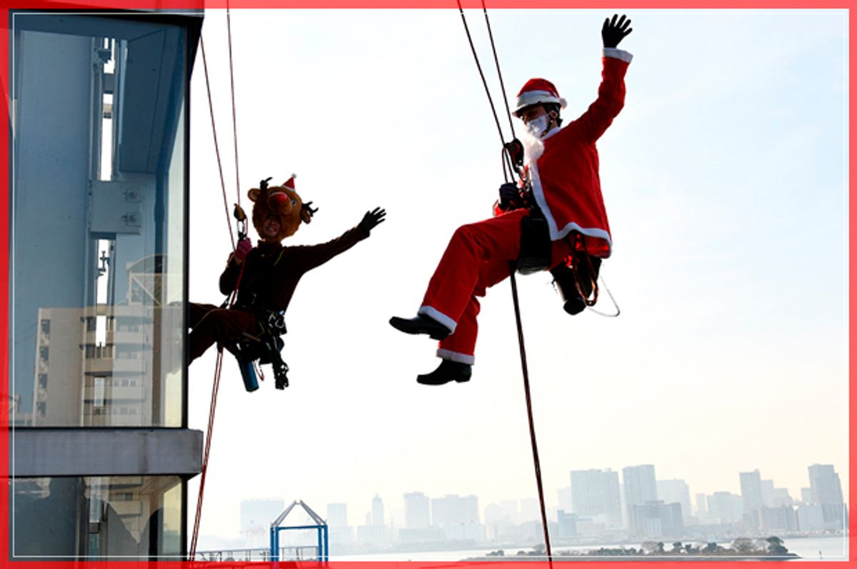 Workers in Santa Claus (R) and reindeer (L) costumes wave while cleaning windows outside the "Decks Tokyo Beach" shopping mall along Tokyo's waterfront on December 21, 2016.
The annual Christmas promotional event was held to attract shoppers. / AFP / TOSHIFUMI KITAMURA        (Photo credit should read TOSHIFUMI KITAMURA/AFP/Getty Images) (Afp/getty Images)