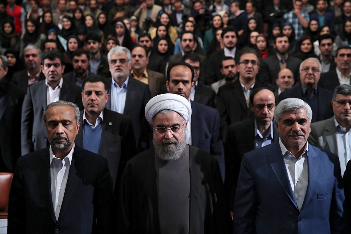 In this photo released by official website of the office of the Iranian Presidency, President Hassan Rouhani, center, Science Minister Mohammad Farhadi, right, and head of the President's office Mohammad Nahavandian, left, listen to the national anthem at the start of a ceremony marking Student Day at Tehran University in Tehran, Iran, Tuesday, Dec. 6, 2016. Rouhani said Tuesday his country will not allow incoming U.S. President Donald Trump to "tear up" Tehran's landmark nuclear deal with world powers. His remarks underscore Iranian leaders' attempts to calm concerns over the future of the deal in the wake of Trump's election. (Iranian Presidency Office via AP) (AP)