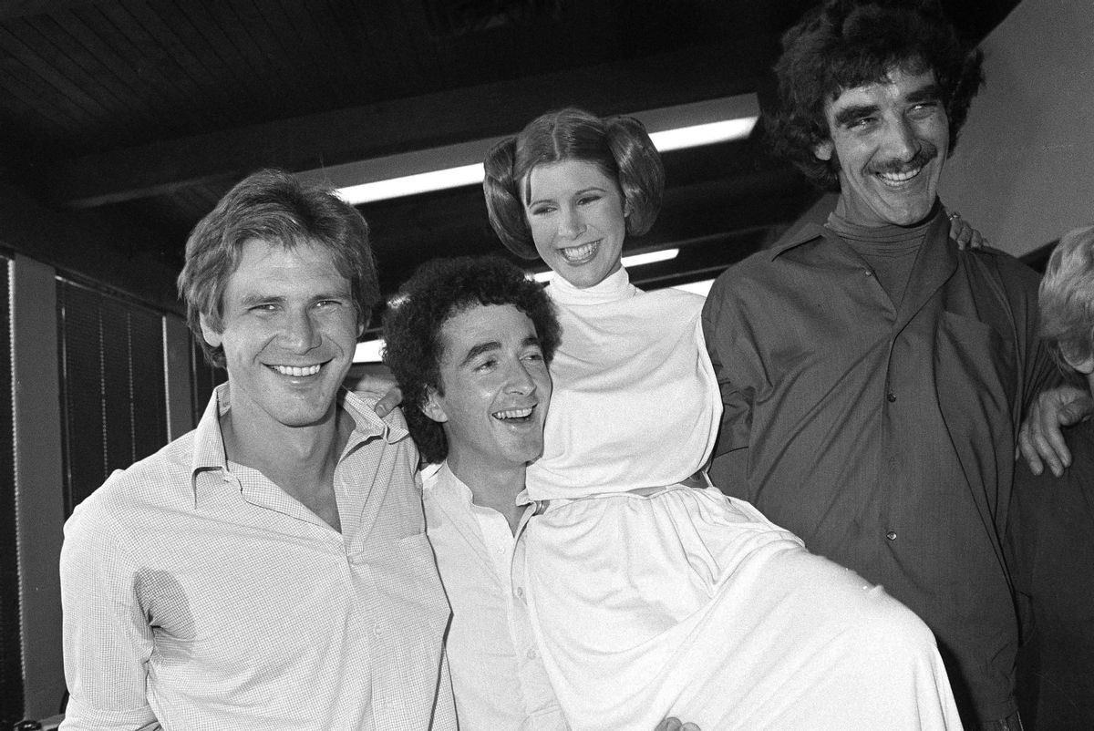 FILE - In this Oct. 5, 1978 photo, from left, actors Harrison Ford, Anthony Daniels, Carrie Fisher and Peter Mayhew take a break from filming a television special in Los Angeles to be telecast during the holidays. On Tuesday, Dec. 27, 2016, a publicist says Fisher has died at the age of 60. (AP Photo/George Brich, File) (AP)
