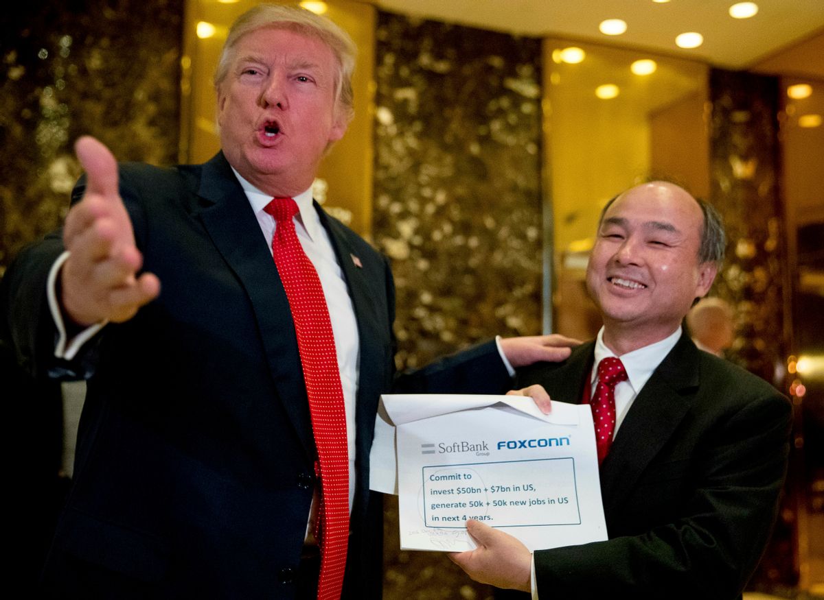 FILE - In this Tuesday, Dec. 6, 2016, file photo, President-elect Donald Trump, left, accompanied by SoftBank CEO Masayoshi Son, speaks to members of the media at Trump Tower in New York. Trump talked up Japanese mogul Son, who after meeting with the president-elect in New York, spotlighted his plan to invest $50 billion and create 50,000 jobs. (AP Photo/Andrew Harnik, File) (AP)