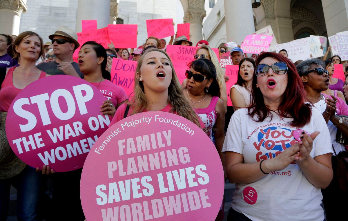 FILE - In this Sept. 9, 2015, file photo, Planned Parenthood supporters rally for women's access to reproductive health care on "National Pink Out Day'' at Los Angeles City Hall. One of President-elect Donald Trump’s first, and defining, acts next year could come on Republican legislation to cut off taxpayer money from Planned Parenthood. Trump sent mixed signals during the campaign about the 100-year-old organization which provides birth control, abortions and various women's health services. He said "millions of women are helped by Planned Parenthood," but also endorsed efforts to defund it. (AP Photo/Nick Ut, File) (AP)