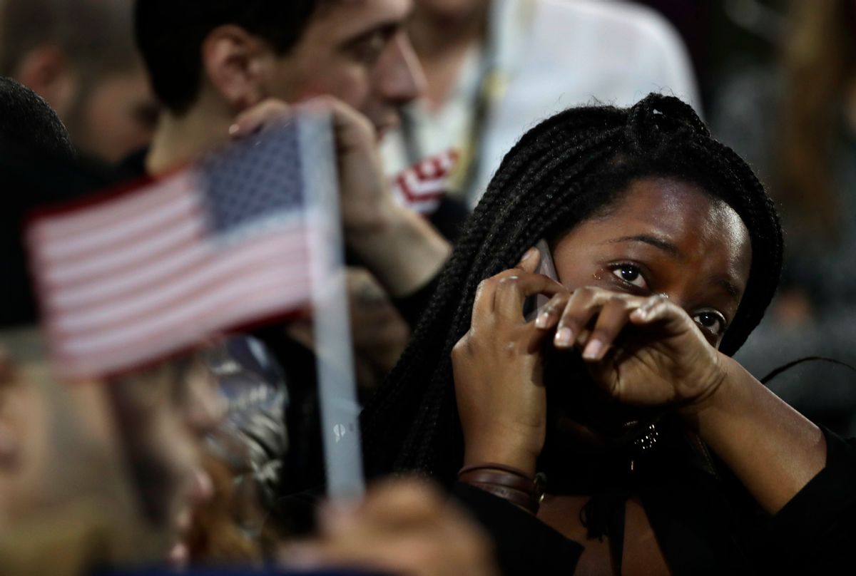 FILE - In this Nov. 8, 2016 file photo, a woman weeps as election results are reported during Democratic presidential nominee Hillary Clinton's election night rally in the Jacob Javits Center glass enclosed lobby in New York.  As Donald Trump approaches his inauguration as president, young Americans have a deeply pessimistic view about his incoming administration, with young blacks, Latinos and Asian Americans particularly concerned about what’s to come in the next four years.  (AP Photo/Frank Franklin II) (AP)