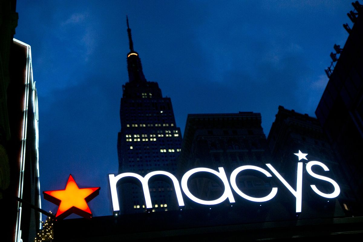 FILE - In this Nov. 21, 2013, file photo, with the Empire State building in the background, the Macy's logo is illuminated on the front of the department store in New York. (AP Photo/Mark Lennihan, File) (AP)