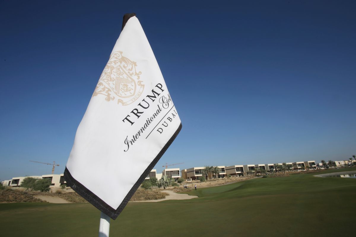 In this Tuesday, Dec. 20, 2016 photo, a flag flies on a green lined with villas at the Trump International Golf Club, in Dubai, United Arab Emirates. The 18-hole golf course in Dubai bearing Donald Trump’s name exemplifies the questions surrounding his international business interests. The course will open in February 2017 in the United Arab Emirates, but concerns about security, financial agreements and other matters have yet to be answered by the incoming 45th American president. (AP Photo/Kamran Jebreili) (AP)