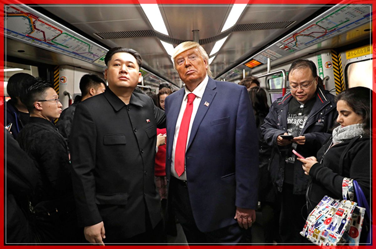 Kim Jong Un and Donald Trump impersonators, Howard, left, and Dennis, right, (who only give their first name) stand side by side on a train to promote a music video they created in Hong Kong, Wednesday, Jan. 25, 2017. (AP Photo/Vincent Yu) (AP)