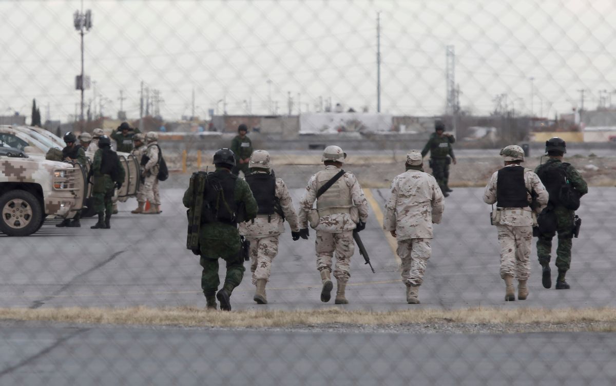 Soldiers walk at the airport after the extradition of drug lord Joaquin "El Chapo" Guzman in Ciudad Juarez, Mexico, Thursday, Jan. 19, 2017. Mexico's Foreign Relations Department announced Guzman was handed over to U.S. authorities for transportation to the U.S. on Thursday, the last day of President Barack Obama's administration and a day before Donald Trump is to be inaugurated. (AP Photo/Christian Torres) (AP)