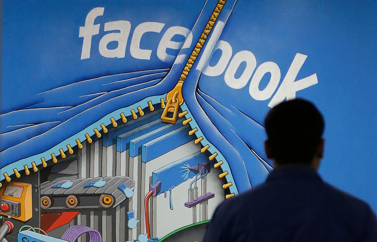 FILE - In this Friday, March 15, 2013, file photo, a Facebook employee walks past a sign at Facebook headquarters in Menlo Park, Calif. Despite loudly touted efforts, the tech industry is making very little progress in diversifying its workforce, especially in technical and leadership positions. In 2014, 2 percent of Googlers were black and 3 percent were Hispanic, numbers that haven’t changed since. The picture is similar at Facebook and Twitter. (AP Photo/Jeff Chiu, File) (AP)