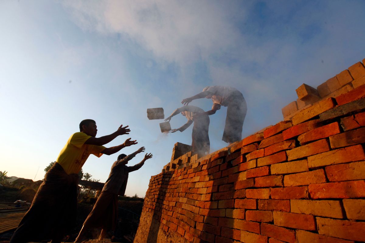 In this Friday, Jan. 13, 2017 photo, workers unload bricks at a brick-making factory in Naypyitaw, Myanmar. As bricks continue to be used in construction throughout Myanmar, traditional craftsmen who produce hand-made bricks are facing competition from machine-made bricks which are produced more efficiently. (AP Photo/Aung Shine Oo, File) (AP)