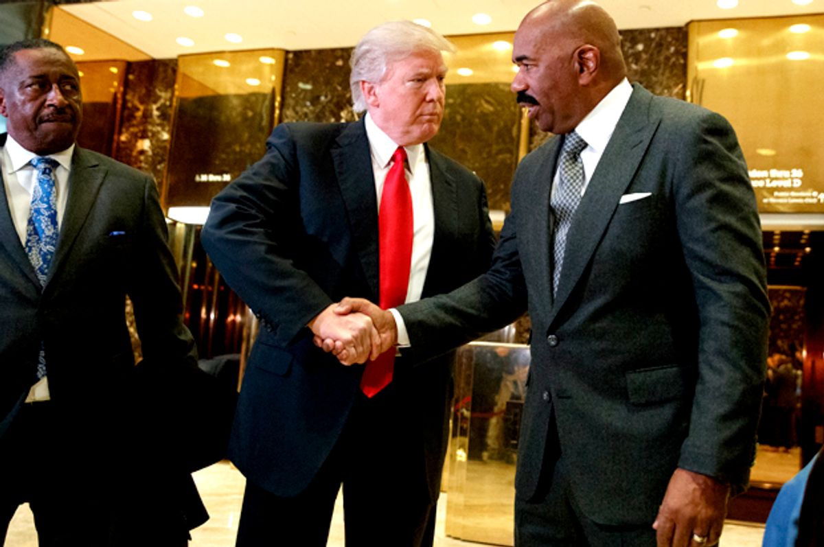 Donald Trump shakes hands with comedian Steve Harvey in the lobby of Trump Tower in New York   (AP/Evan Vucci)