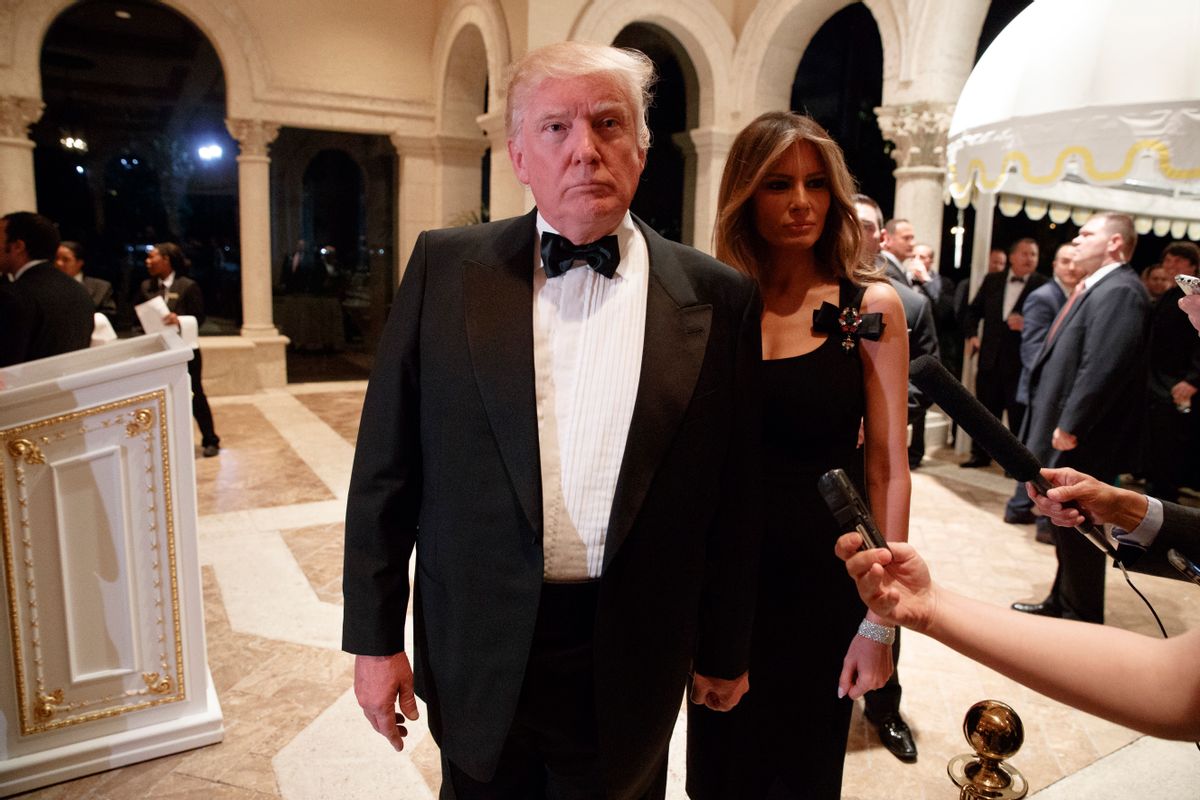 Melania Trump, right, looks on as her husband President-elect Donald Trump talks to reporters during a New Year's Eve party at Mar-a-Lago, Saturday, Dec. 31, 2016, in Palm Beach, Fla. (AP)
