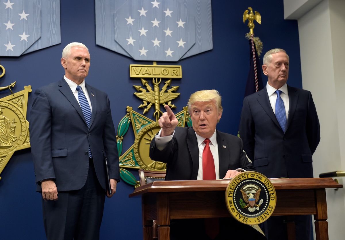 President Donald Trump, center, gestures after signing two executive action at the Pentagon in Washington, Friday, Jan. 27, 2017, with Vice President Mike Pence, left, and Defense Secretary James Mattis, right, at his side. (AP Photo/Susan Walsh) (AP)