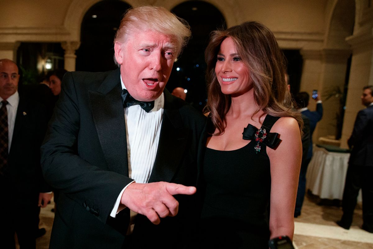 Melania Trump, right, looks on as her husband President-elect Donald Trump talks to reporters during a New Year's Eve party at Mar-a-Lago, Saturday, Dec. 31, 2016, in Palm Beach, Fla. (AP Photo/Evan Vucci) (AP)