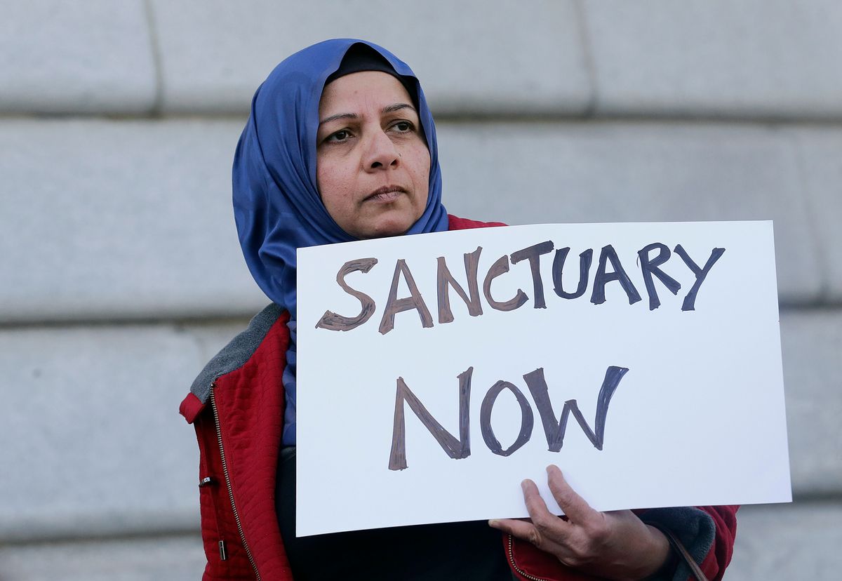Moina Shaiq holds a sign at a rally outside of City Hall in San Francisco, Wednesday, Jan. 25, 2017. President Donald Trump moved aggressively to tighten the nation's immigration controls Wednesday, signing executive actions to jumpstart construction of his promised U.S.-Mexico border wall and cut federal grants for immigrant-protecting "sanctuary cities." (AP Photo/Jeff Chiu) (AP)