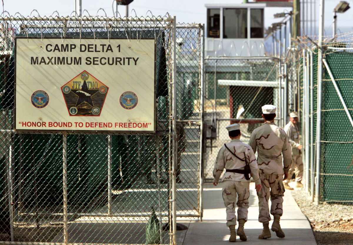 FILE - In this June 27, 2006 file photo, reviewed by a US Department of Defense official, US military guards walk within Camp Delta military-run prison, at the Guantanamo Bay US Naval Base, Cuba. (AP Photo/Brennan Linsley, file) (AP Photo/Brennan Linsley)