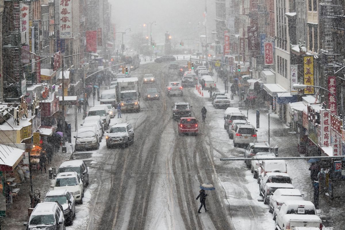 Snow falls on pedestrians and traffic making their way across East Broadway in Lower Manhattan, Saturday, Jan. 7, 2017.  (AP Photo/Mary Altaffer) (AP)