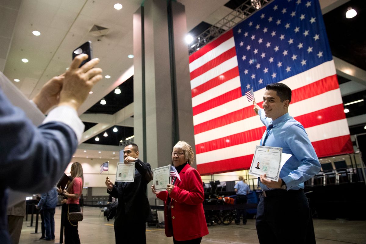 Erik Danialian, a 21-year-old immigrant from Iran, poses with his U.S citizenship certificate in front of a large U.S. flag after a naturalization ceremony at the Los Angeles Convention Center, Wednesday, Feb. 15, 2017, in Los Angeles. About 3,000 people took the oath in the morning and more than 3,500 others were expected during an afternoon ceremony, according to U.S. Citizenship and Immigration Services officials. (AP Photo/Jae C. Hong) (AP)