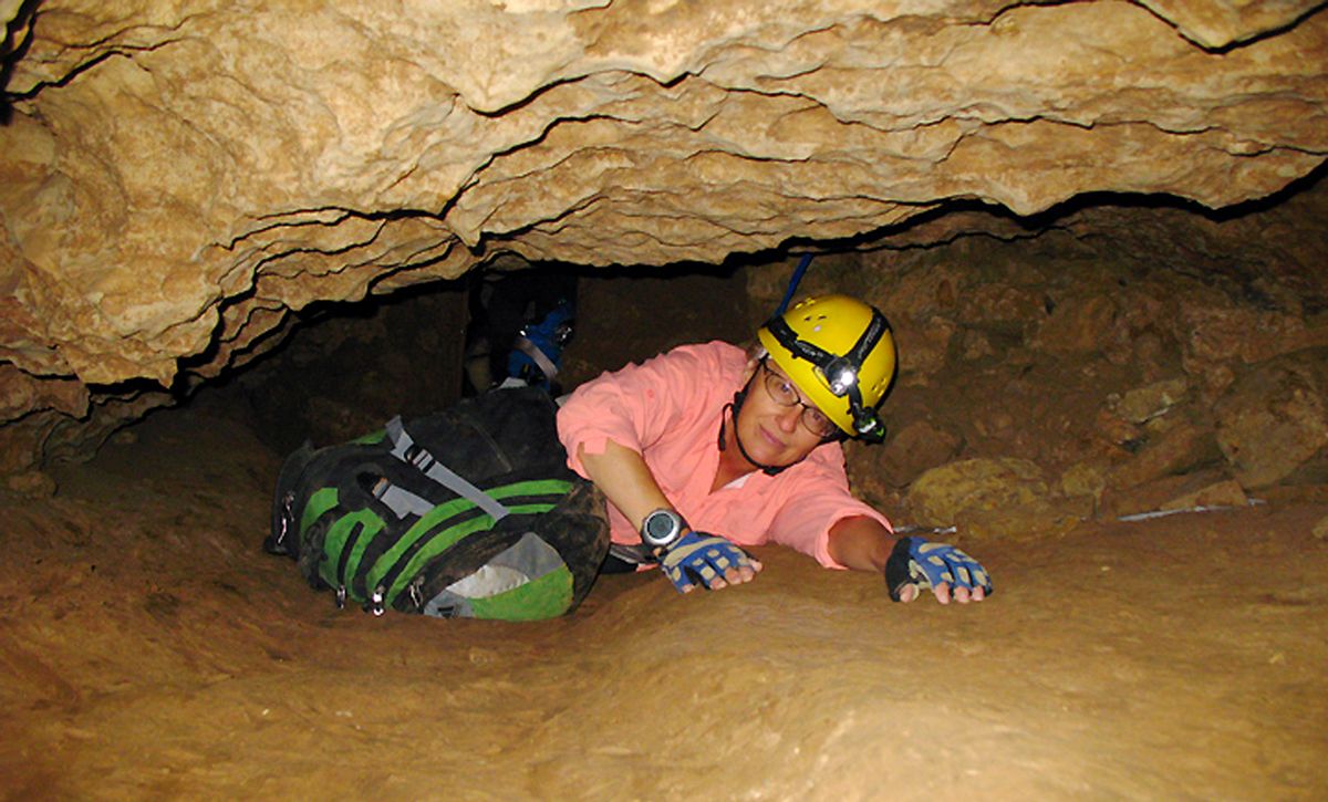 FILE - In this July 3, 2008, file photo, New Mexico Tech professor Penny Boston crawls through the Mud Turtle Passage on the way to the Snowy River formation during an expedition in Fort Stanton Cave, N.M. Boston, who discovered extreme life in New Mexico caves in 2008, presented new findings on Friday, Feb. 17, 2017 of microbes trapped in crystals in Mexico that could be 50,000 years old. (AP Photo/Susan Montoya Bryan) (AP)