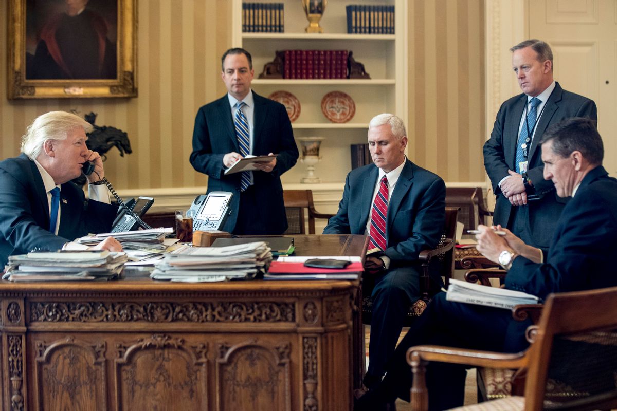 FILE - In this Jan. 28, 2017, file photo, President Donald Trump accompanied by, from second from left, Chief of Staff Reince Priebus, Vice President Mike Pence, White House press secretary Sean Spicer and National Security Adviser Michael Flynn speaks on the phone with Russian President Vladimir Putin in the Oval Office at the White House in Washington.  (AP Photo/Andrew Harnik, File)