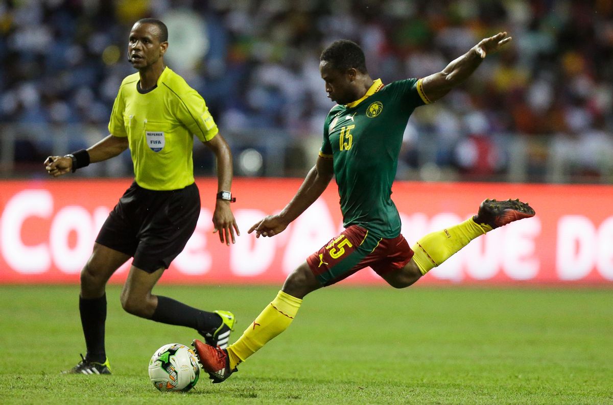 Cameroon's Sebastien Siani shoots the ball next to referee Janny Sikazwe during the African Cup of Nations final soccer match between Egypt and Cameroon at the Stade de l'Amitie, in Libreville, Gabon, Sunday, Feb. 5, 2017. (AP Photo/Sunday Alamba) (AP Photo/Sunday Alamba)