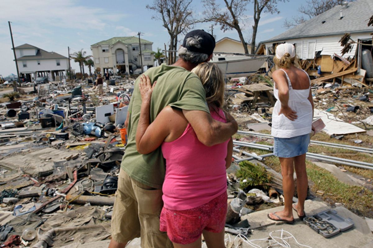 Residents look over debris left in the the aftermath of Hurricane Ike in Galveston, Texas, Sept. 24, 2008.  (AP/David J. Phillip)