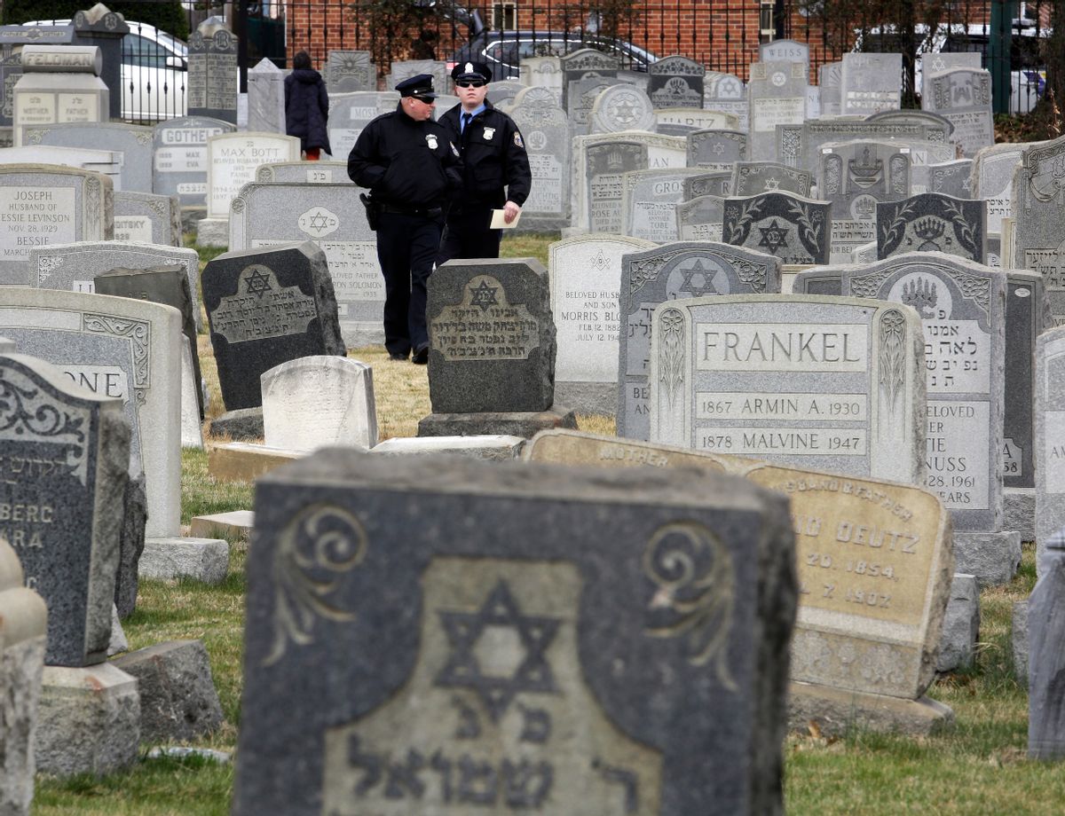 Philadelphia Police walk through Mount Carmel Cemetery, Monday, Feb. 27, 2017, in Philadelphia. More than 100 headstones have been vandalized at the Jewish cemetery in Philadelphia, damage discovered less than a week after similar vandalism in Missouri, authorities said. (AP Photo/Jacqueline Larma) (AP Photo/Jacqueline Larma)