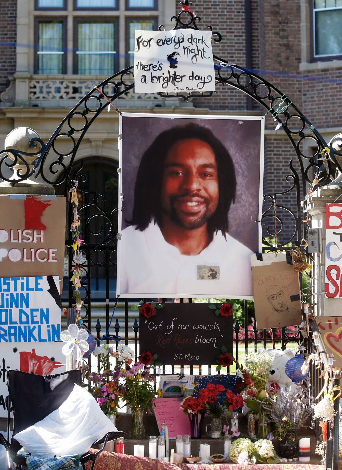 FILE - In this July 25, 2016, file photo, a memorial including a photo of Philando Castile is attached to the gate to the governor's residence where protesters demonstrated in St. Paul, Minn. Attorneys for Jeronimo Yanez, the Minnesota police officer accused of fatally shooting Castile say Castile's gun was accessible and that he was reaching for it when he was killed. A memo filed Tuesday, Feb. 7, 2017, in Ramsey County District Court contradicts prosecutors' claims that St. Anthony Officer Yanez didn't see the weapon and made conflicting statements about it. (AP Photo/Jim Mone, File) (AP)