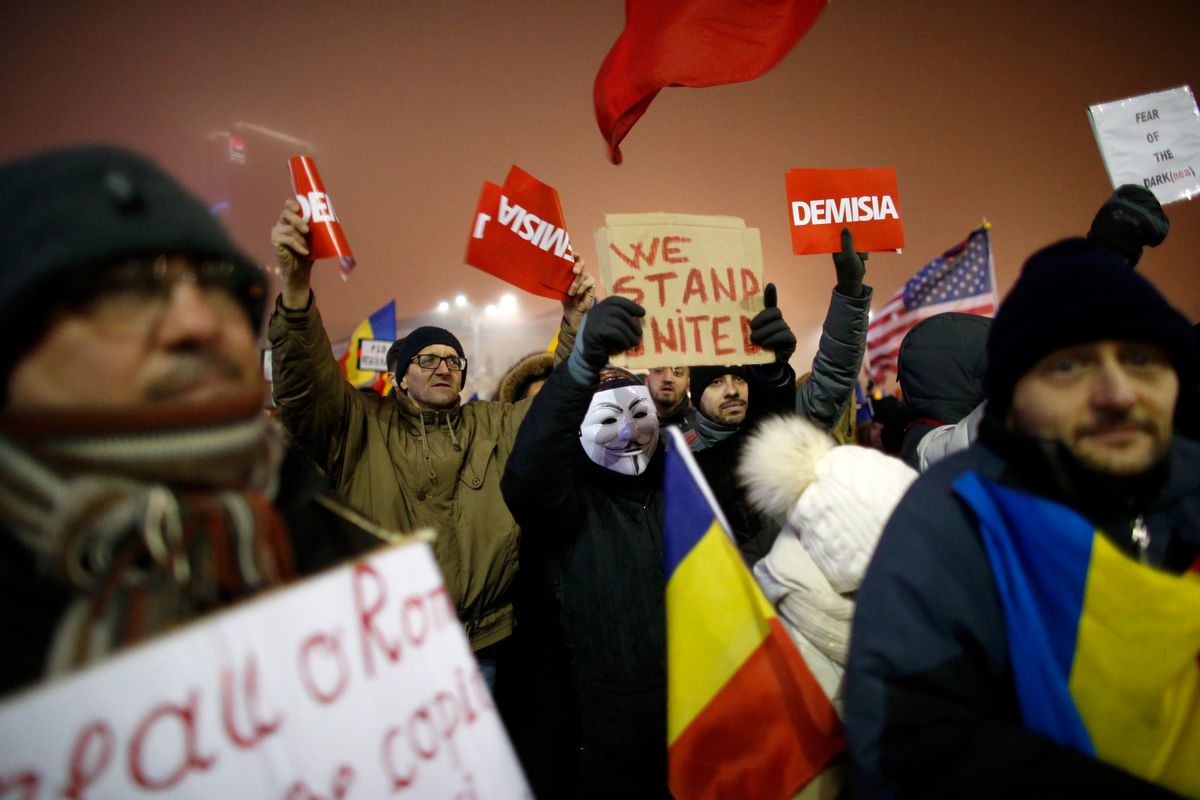 People shout slogans during a protest in Bucharest, Romania, Monday, Feb. 6, 2017. The leader of Romania's ruling center-left coalition said Monday the government won't resign following the biggest demonstrations since the end of communism against a measure that would ease up on corruption. (AP Photo/Darko Bandic) (AP)