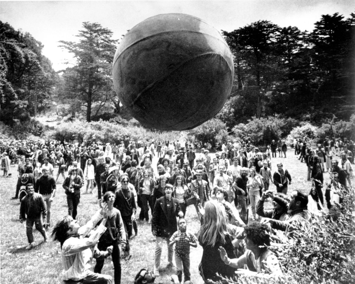 FILE - In this June 21, 1967, file photo, a crowd of hippies keep a large ball, painted to represent a world globe, in the air during a gathering at Golden Gate Park in San Francisco, to celebrate the summer solstice on June 21, day one of "Summer of Love."  (AP Photo, File)