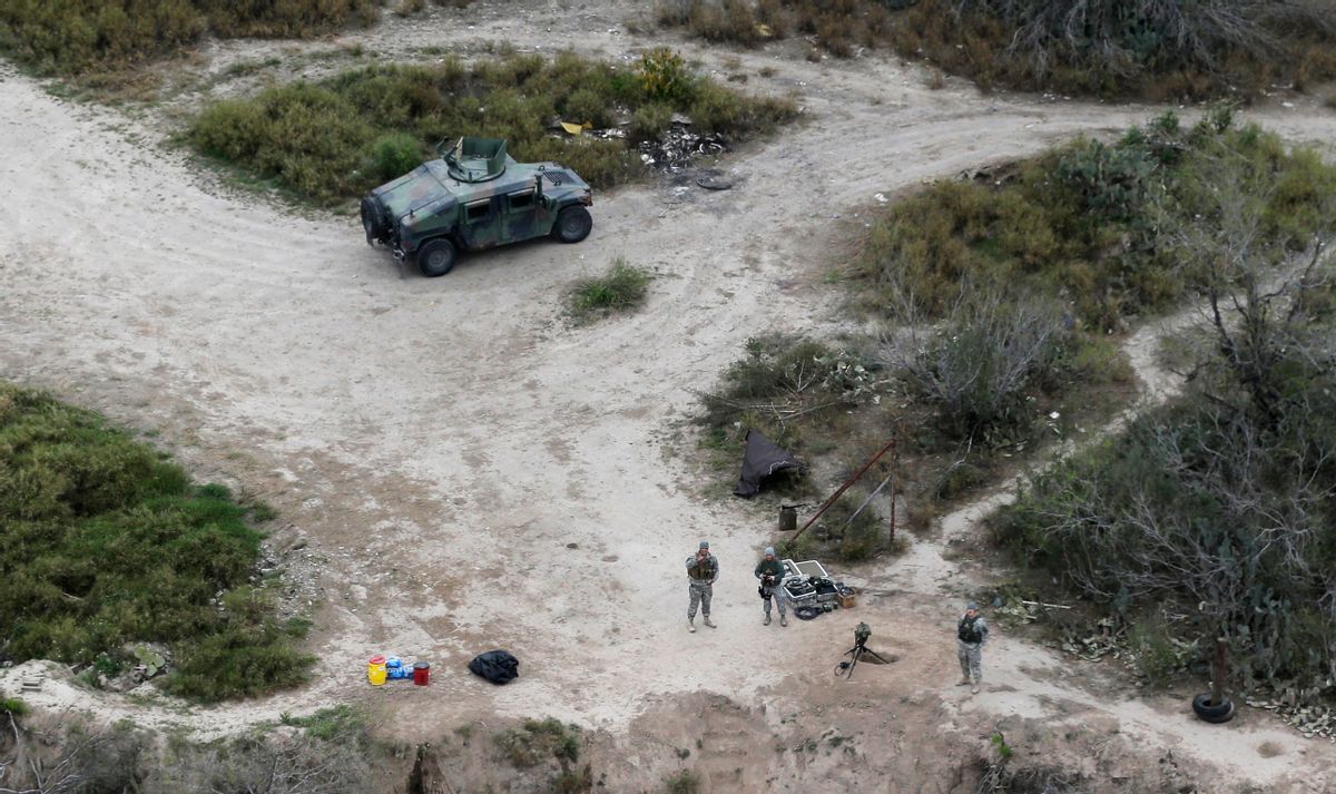 FILE - In this Feb. 24, 2015, file photo, members of the National Guard patrol along the Rio Grande at the Texas-Mexico border in Rio Grande City, Texas. The Trump administration is considering a proposal to mobilize as many as 100,000 National Guard troops to round up unauthorized immigrants, including millions living nowhere near the Mexico border, according to a draft memo obtained by The Associated Press. (AP Photo/Eric Gay, File) (AP)