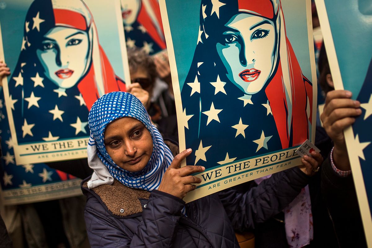 People carry posters during a rally against President Donald Trump's executive order banning travel from seven Muslim-majority nations, in New York's Times Square, Sunday, Feb. 19, 2017. (AP Photo/Andres Kudacki) (AP)
