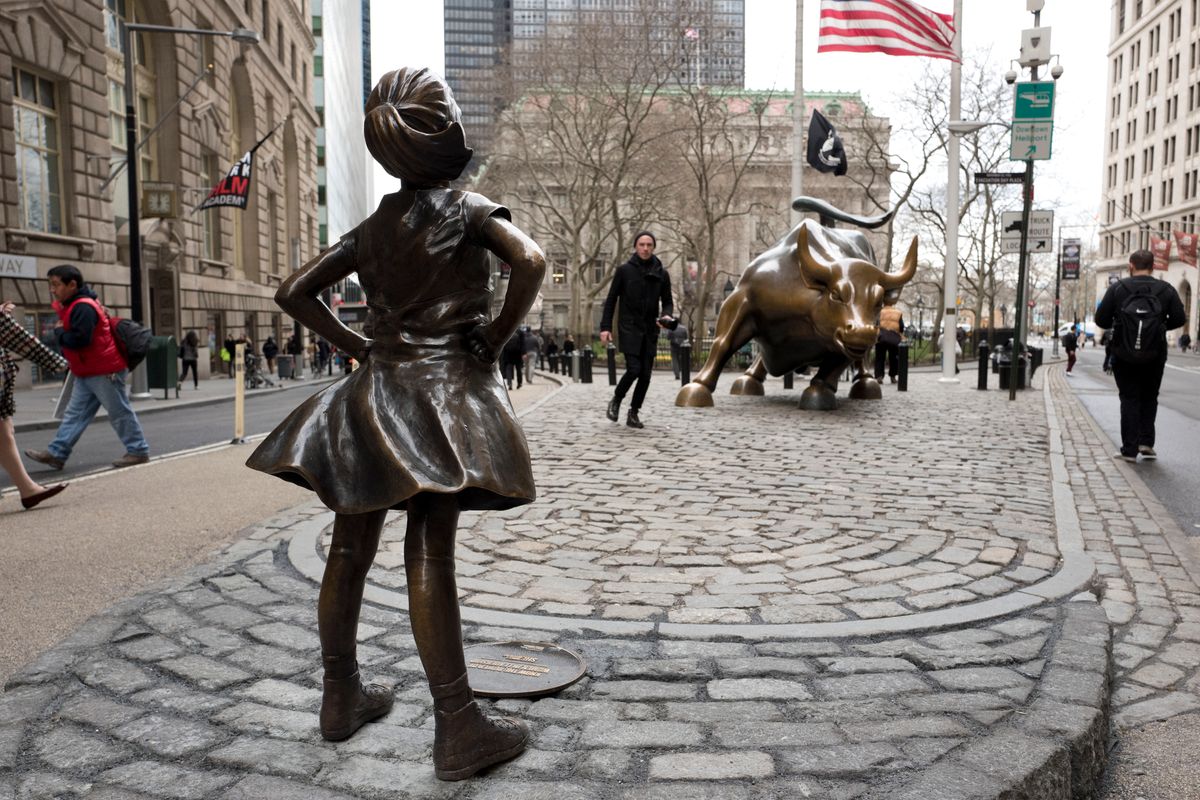A statue titled "Fearless Girl" faces the Wall Street bull, Wednesday, March 8, 2017, in New York.   A big investment firm, State Street Global Advisors, put the statue there to highlight International Women's Day.  The work by artist Kristen Visbal.  (AP Photo/Mark Lennihan) (AP)