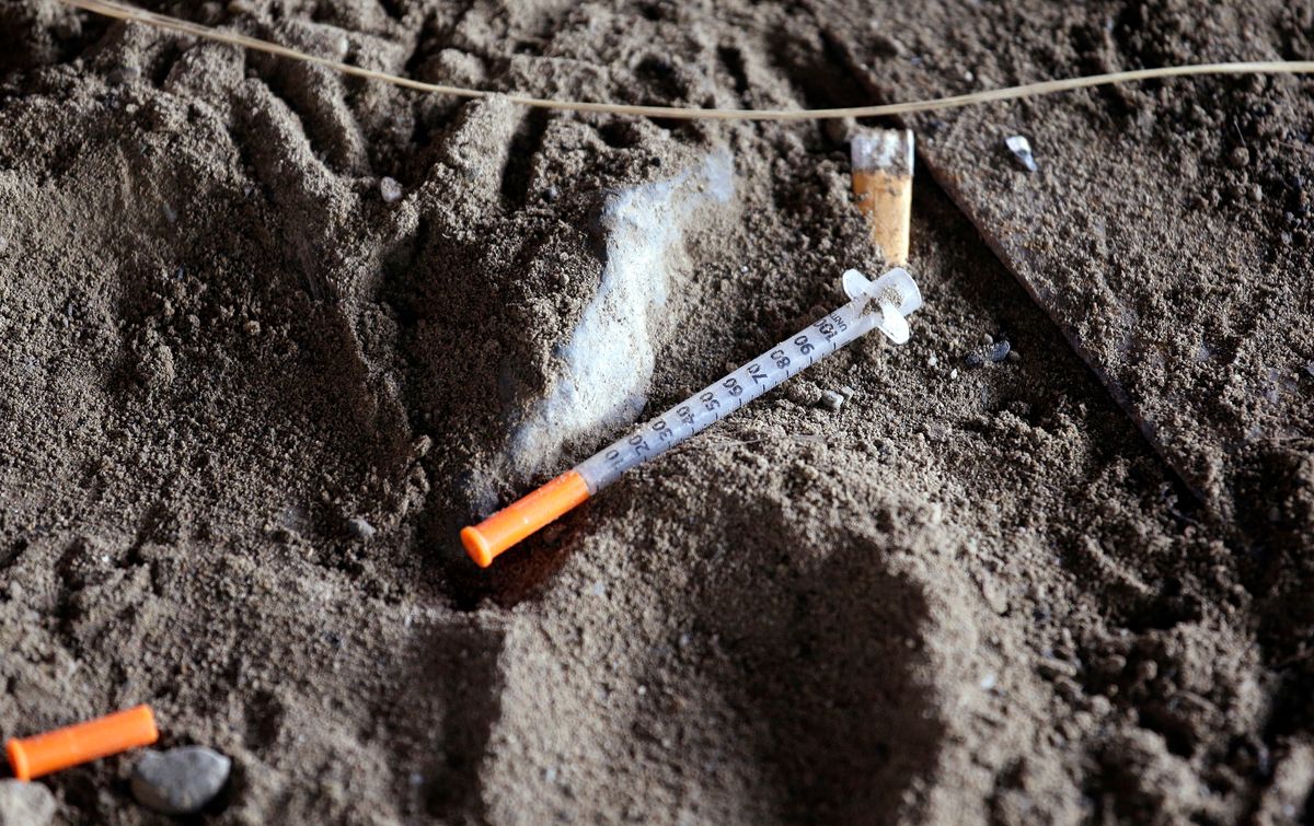 In this Feb. 16, 2017, photo, a discarded syringe sits in the dirt with other debris under a highway overpass where drug users are known to congregate in Everett, Wash. (AP Photo/Elaine Thompson) (AP)